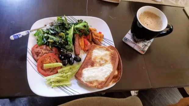 Sautéed greens, peppered tomato, olives, roasted peppers and celery with two slices of cheese toast and a mug of coffee