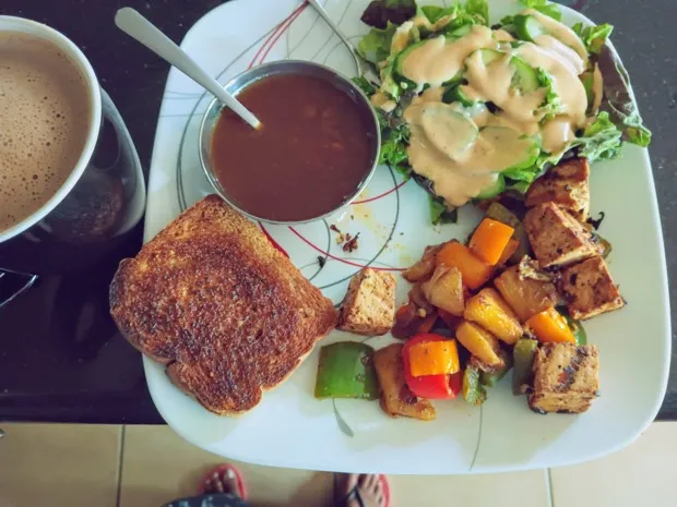 Toast and a bowl of sambar with a dressed leaf salad and a tofu-and-pepper stir-fry