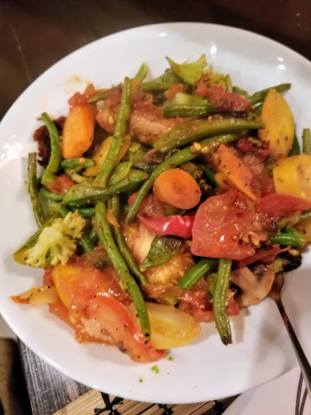 A plate of mixed vegetable stir-fry — green beans, carrots, tomato, cauliflower, peppers and mushrooms